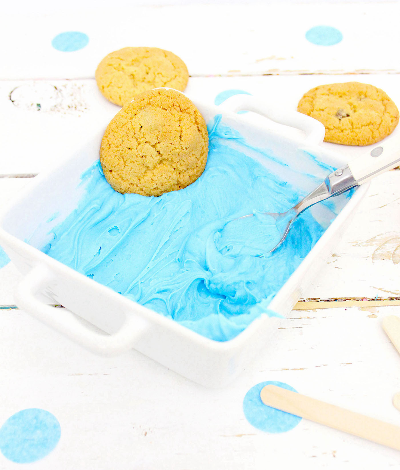 Blue frosting in a white ceramic dish