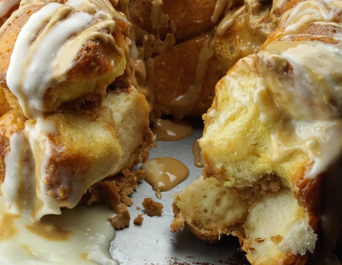 Peanut butter monkey bread recipe with a piece taken out on a baking pan