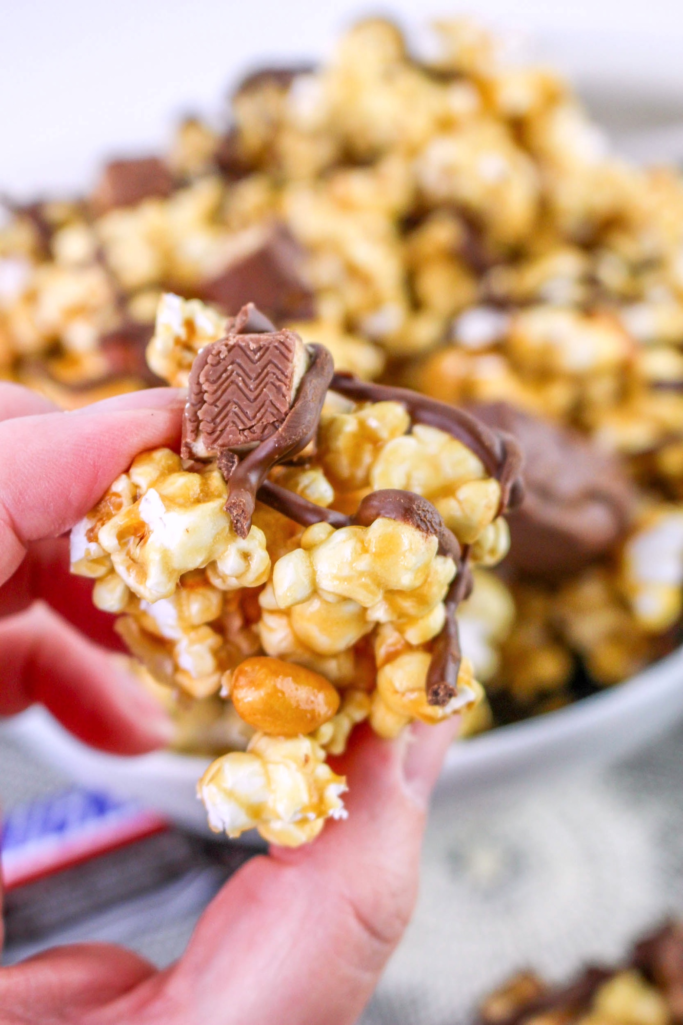 hand holding some snickers popcorn