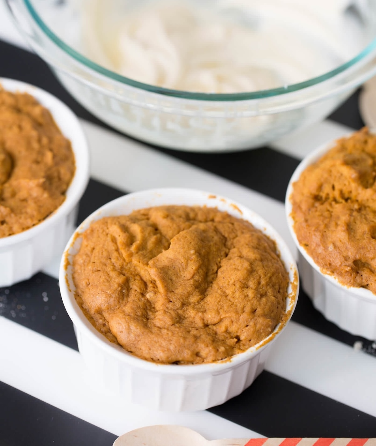Cooked pumpkin mug cakes in the ramekins