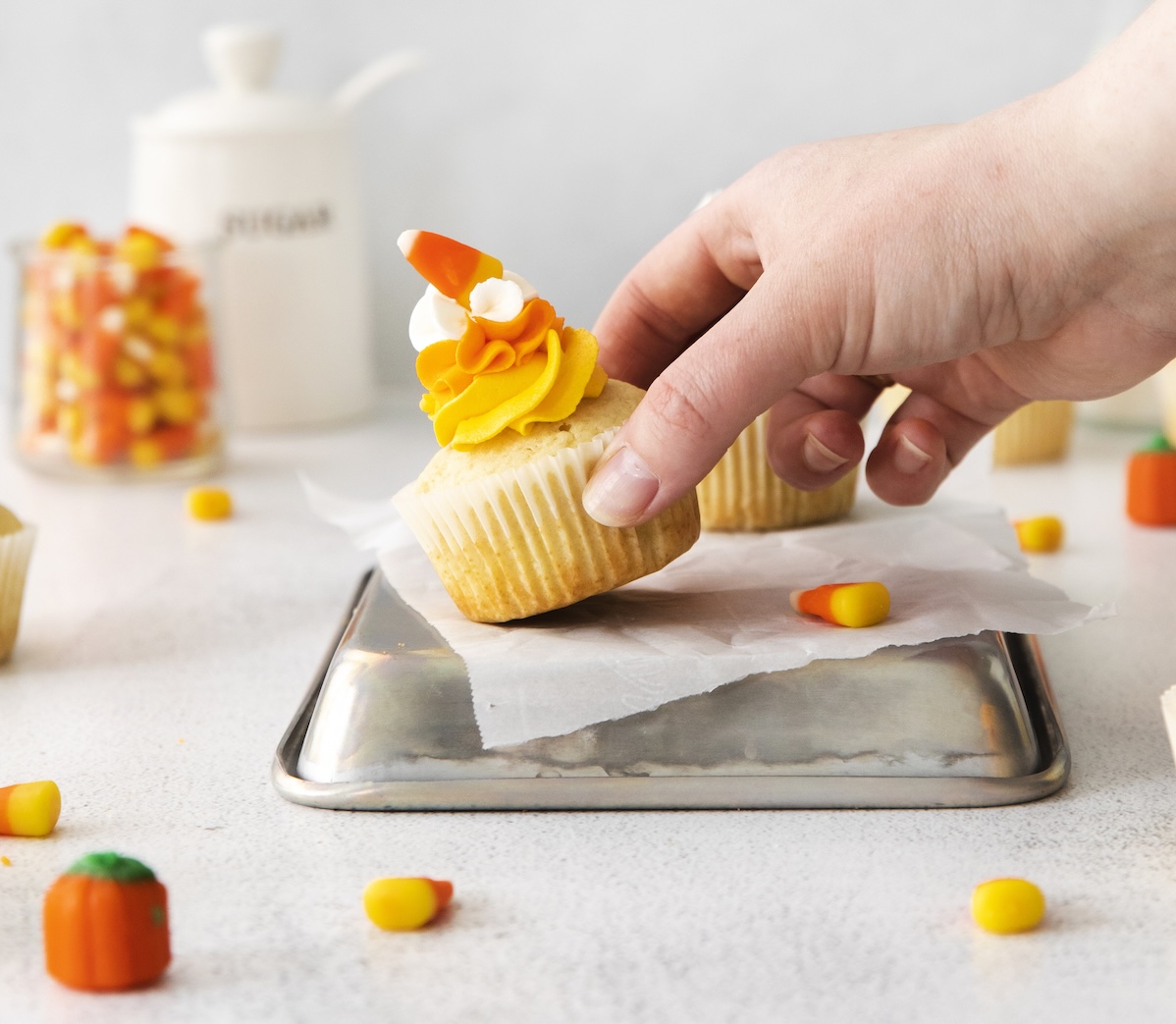 Hand grabbing a Halloween cupcake