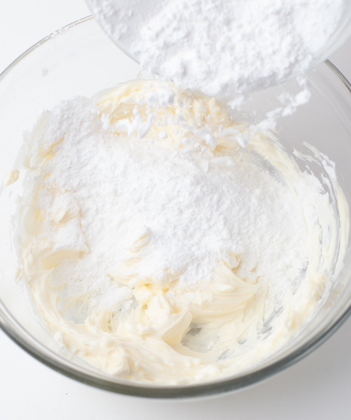 Adding powdered sugar to the cream cheese mixture