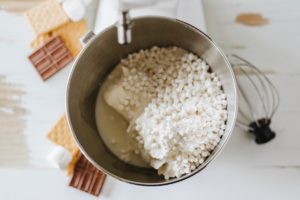 Cream cheese, cool whip, milk, pudding mix, dehydrated marshmallows, and marshmallow topping in a stand mixer