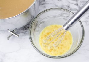 Hot half and half added to a small container of eggs