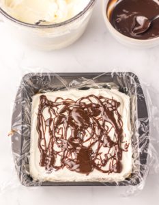 Marshmallow mixture and hot fudge added to the top of the graham crackers