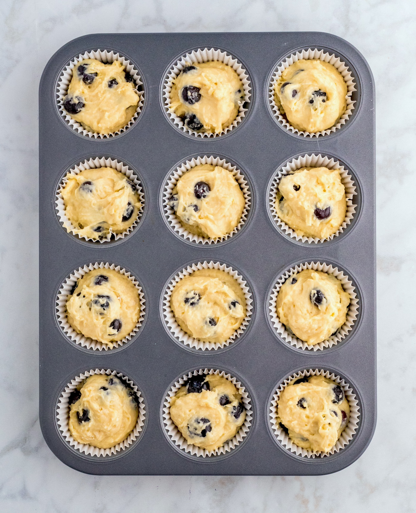 Muffin cups filled with batter