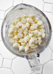 White chocolate chips in a measuring glass