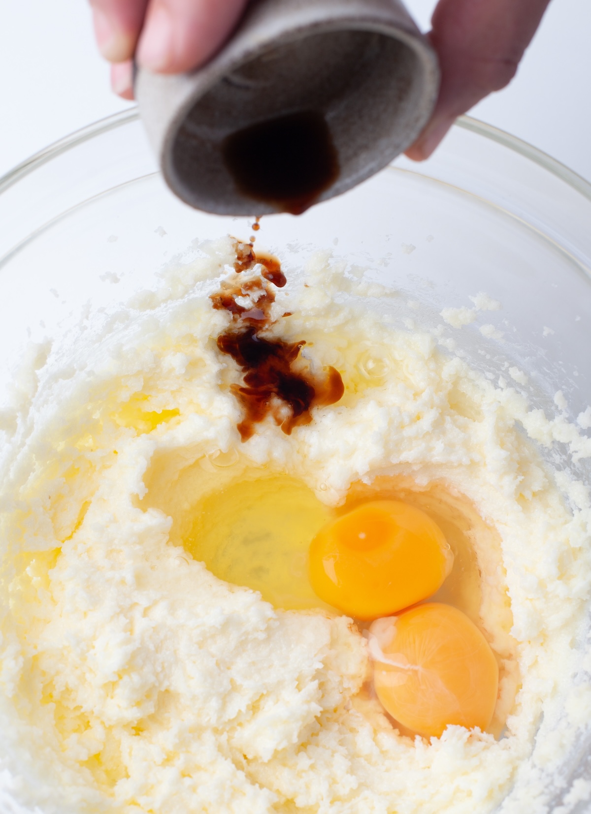 adding the eggs and vanilla to the batter slowly