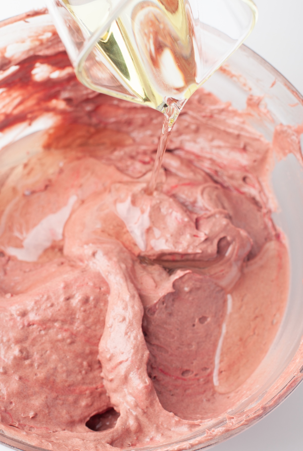 adding the oil into the red velvet batter