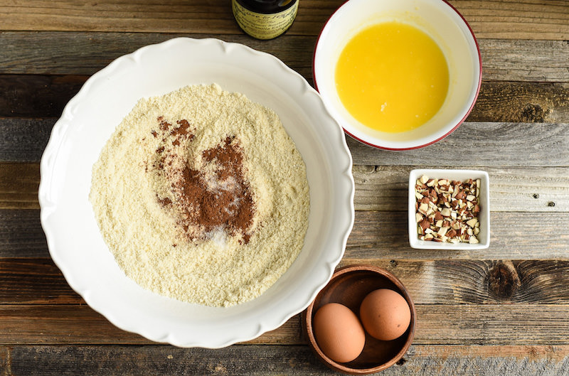 almond flour with cinnamon in a bowl, melted butter, and eggs