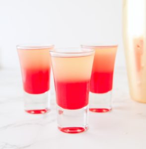 shot glass filled with grenadine and pineapple juice mixture