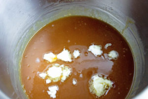 Adding butter and salt to a caramel mixture