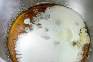Adding double cream to a sugar mixture