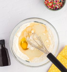 Add milk, melted coconut oil, egg, vanilla extract