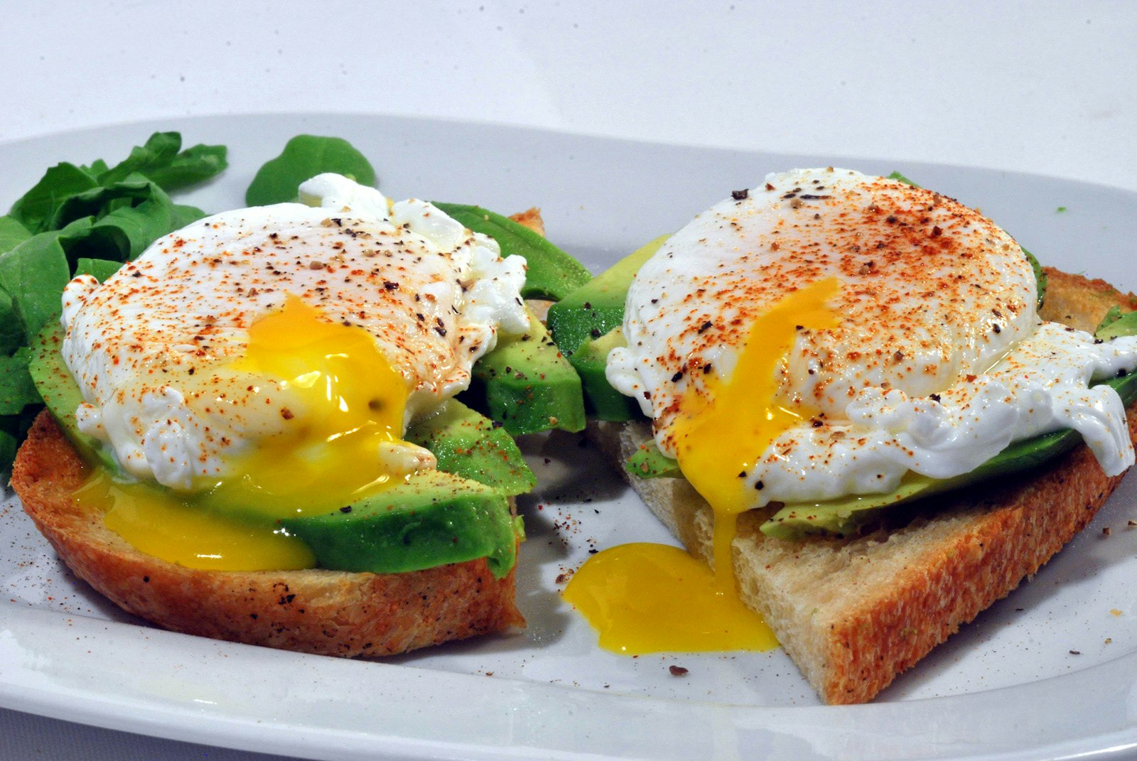 Avocado toast topped with poached eggs