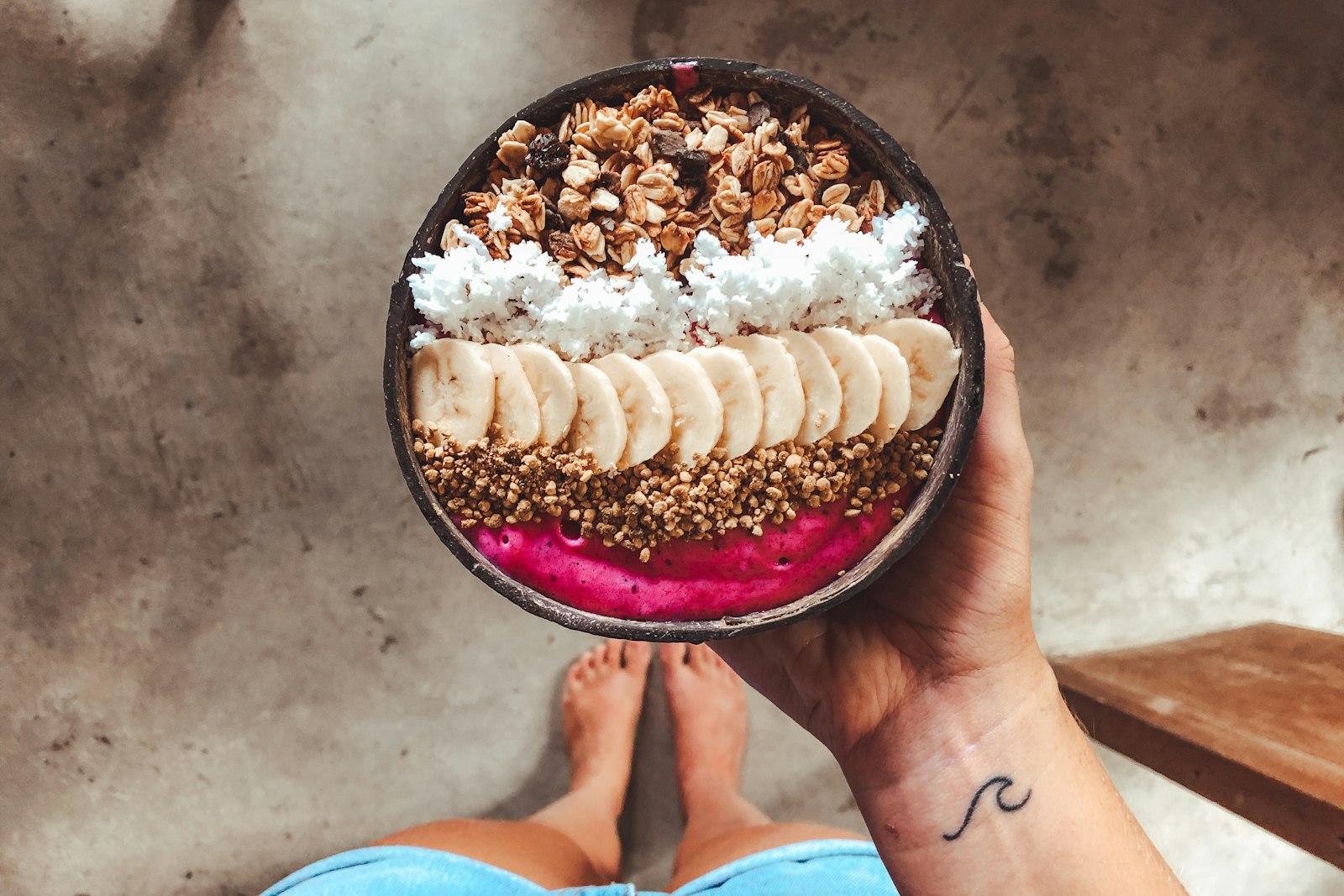 Smoothie bowl topped with banana and granola, one of the best pre workout snacks
