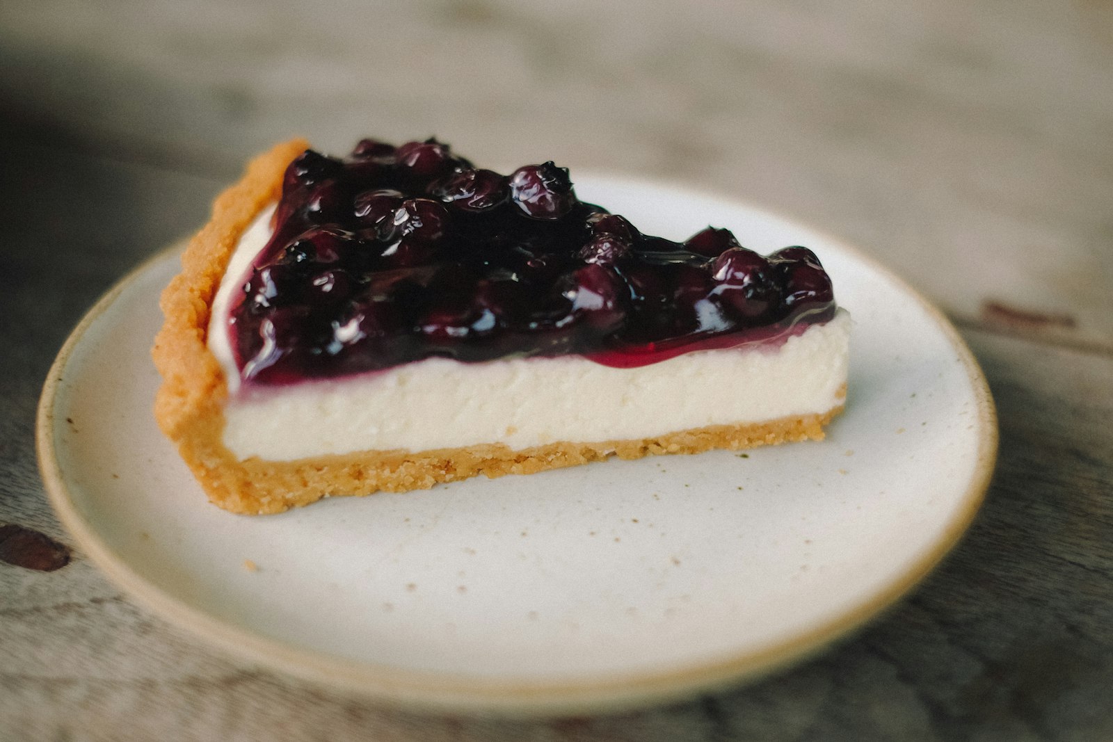 Blueberry topped cheesecake slice