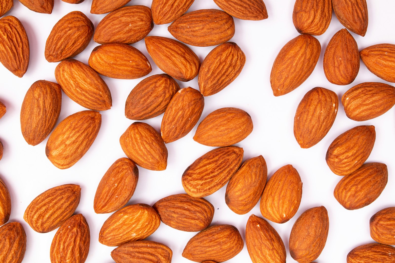 Raw almonds on a white surface