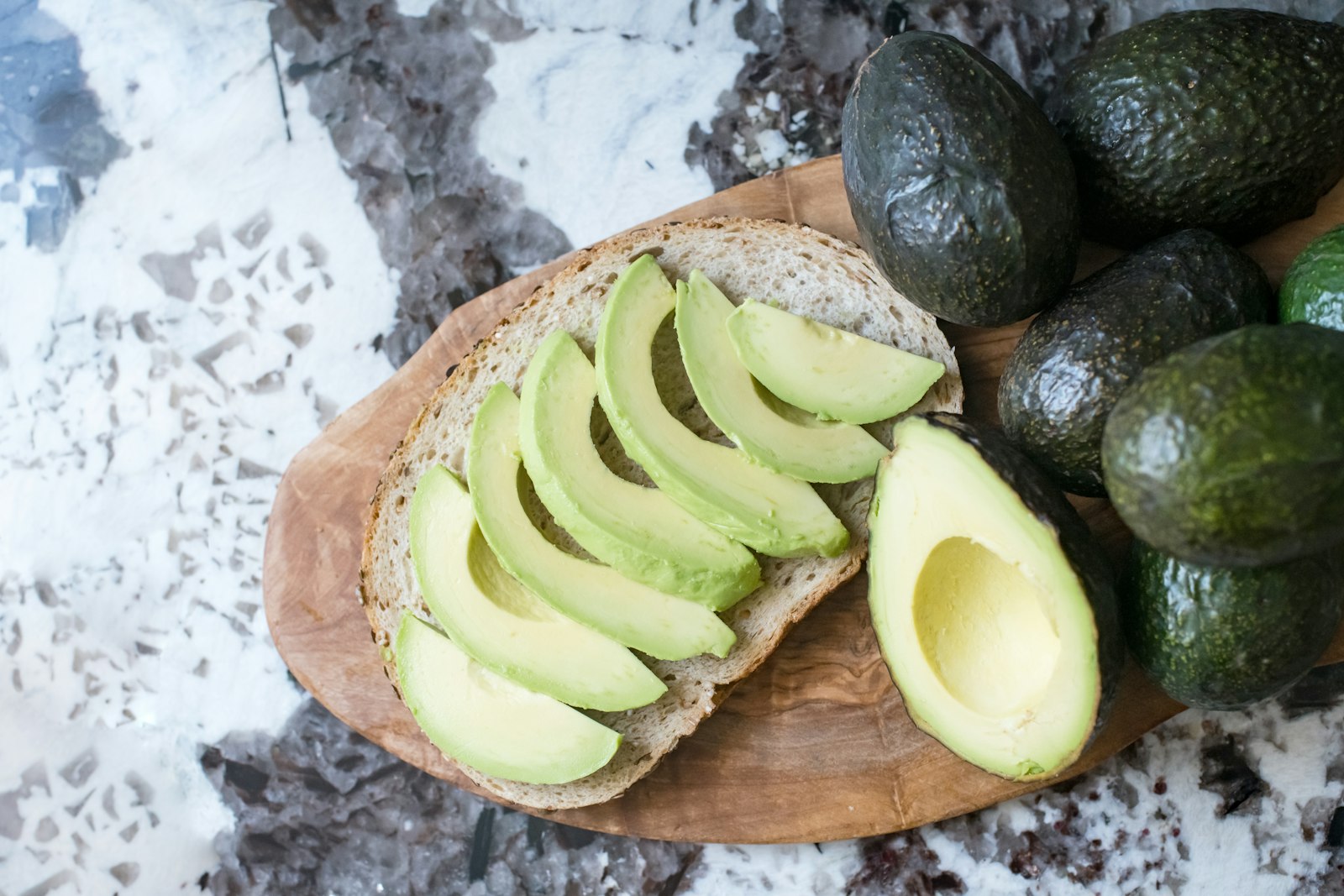 Sliced avocado on a wooden board