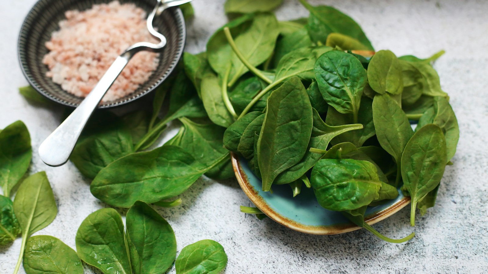 Plate of spinach with a bowl of rice