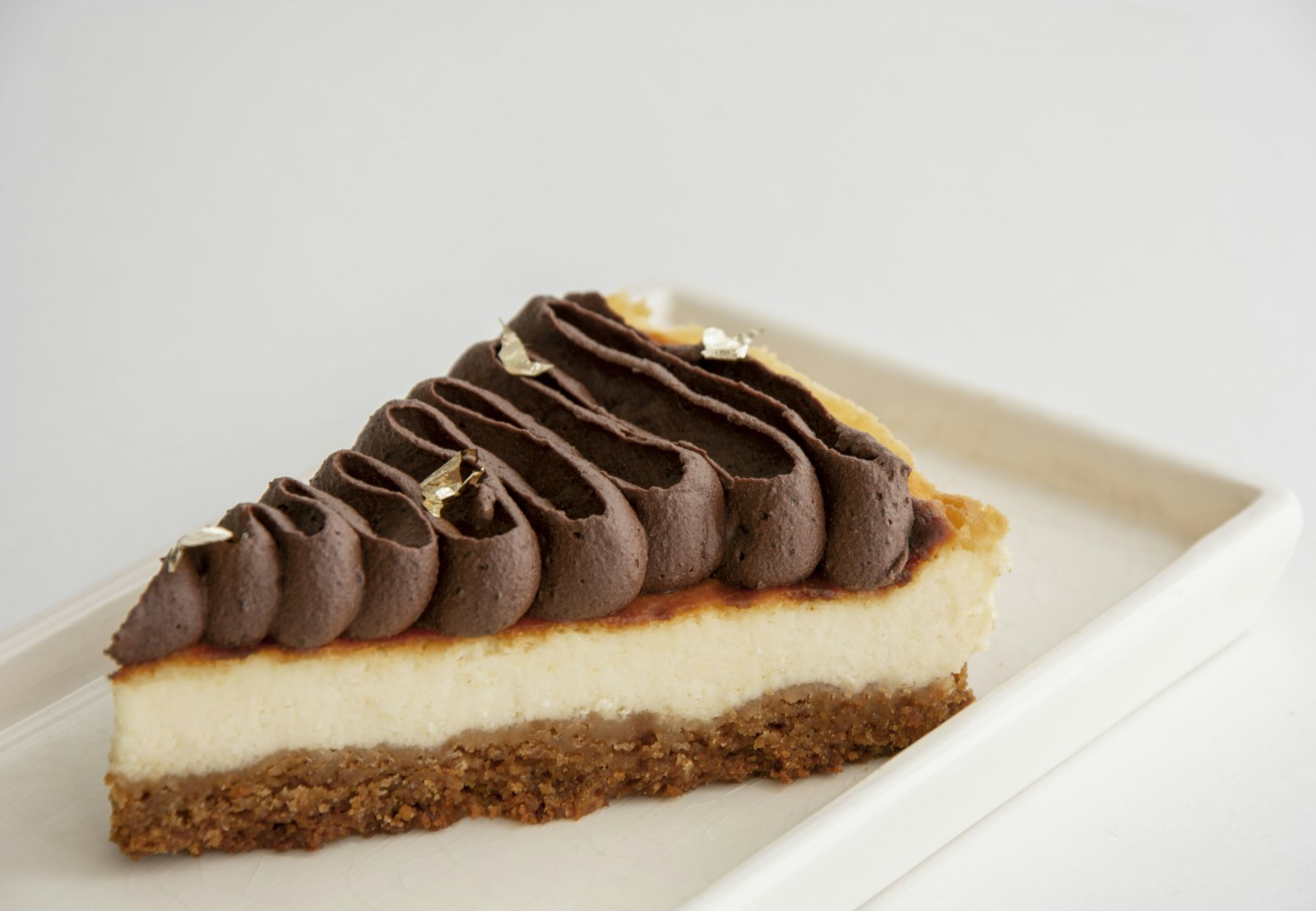 Cheesecake with piped chocolate ganache