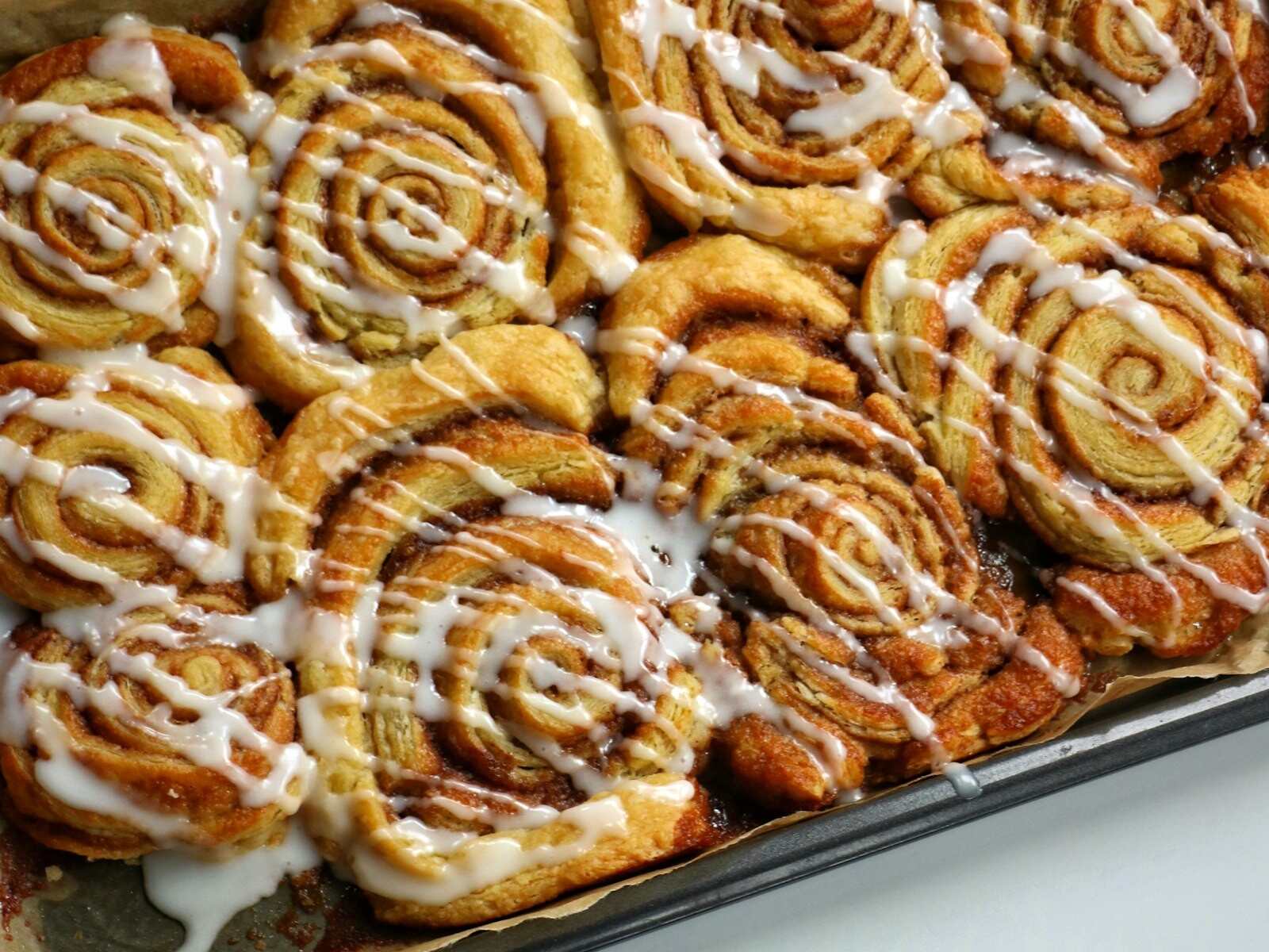 Pan of homemade cinnamon rolls with icing