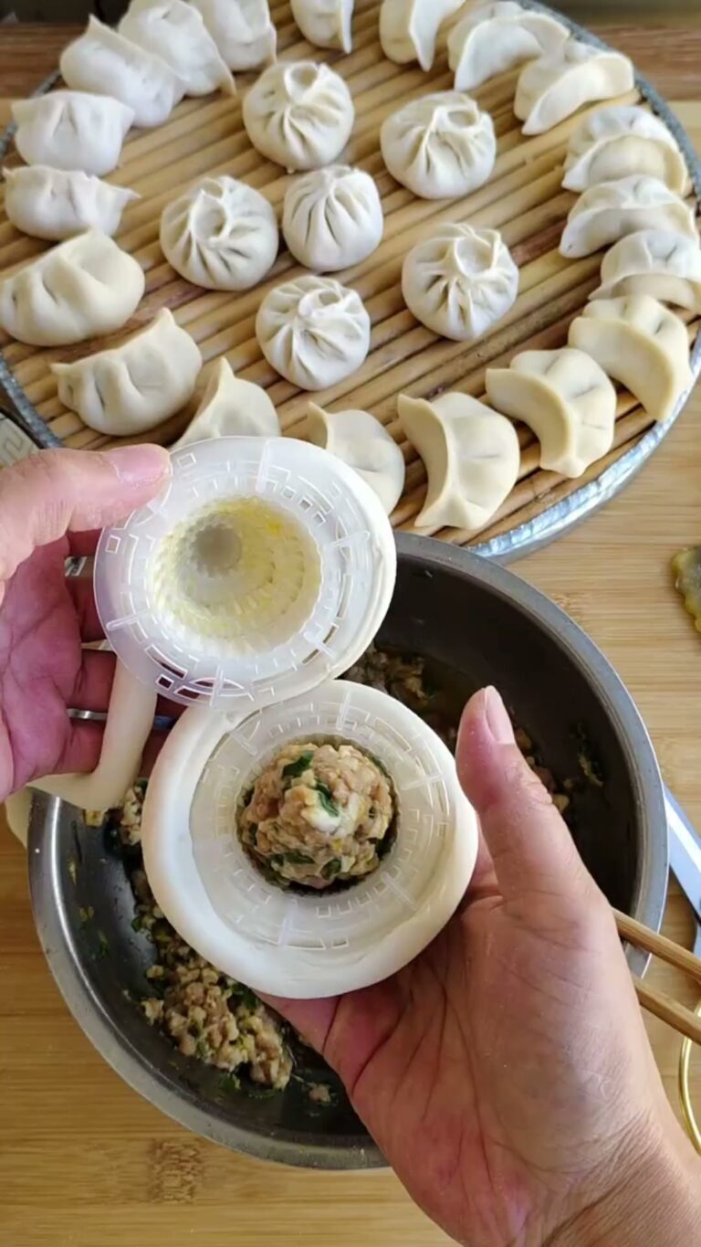 Dumpling mold pressing filling into a wrapper
