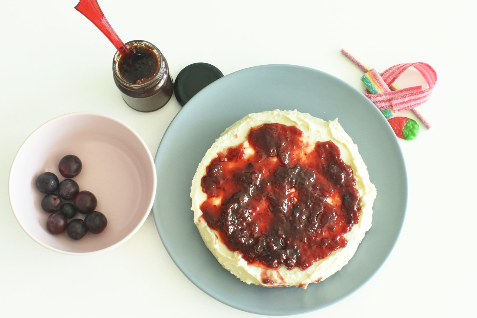 Cream cheese topped with ruby red sauce in a bowl
