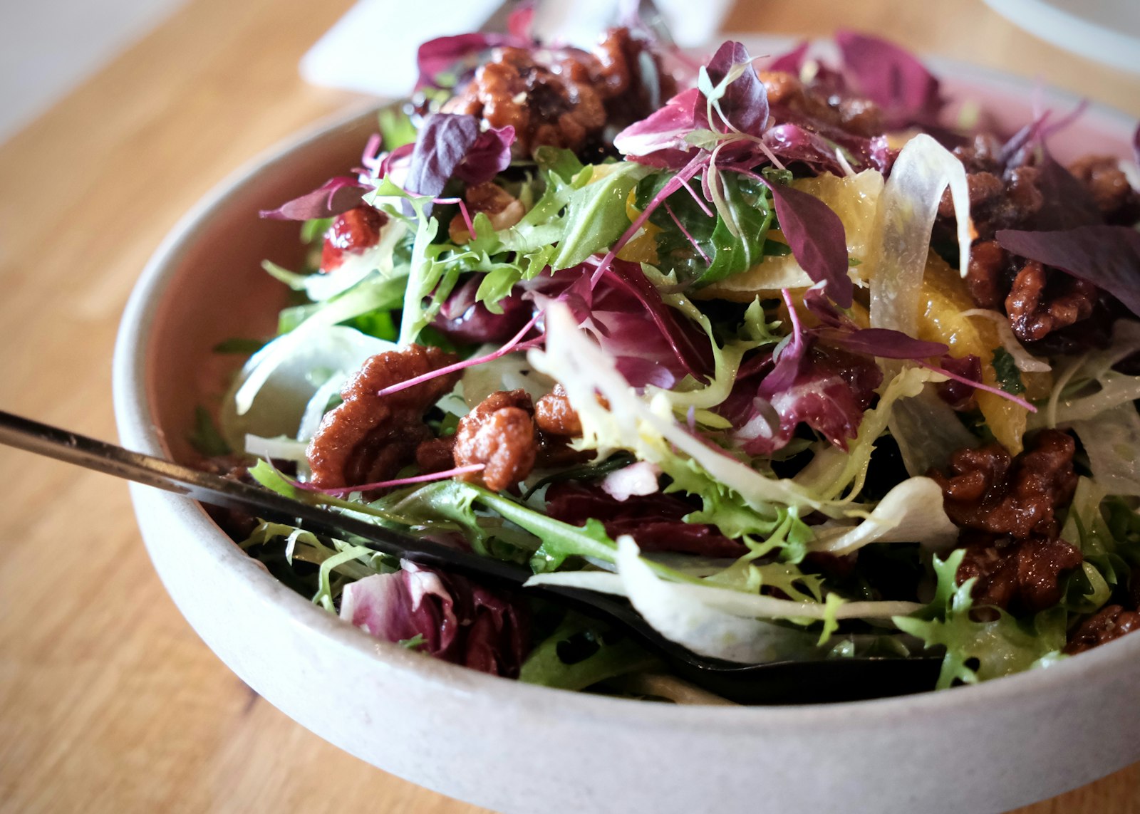 Cranberry pecan salad with crisp greens in a bowl