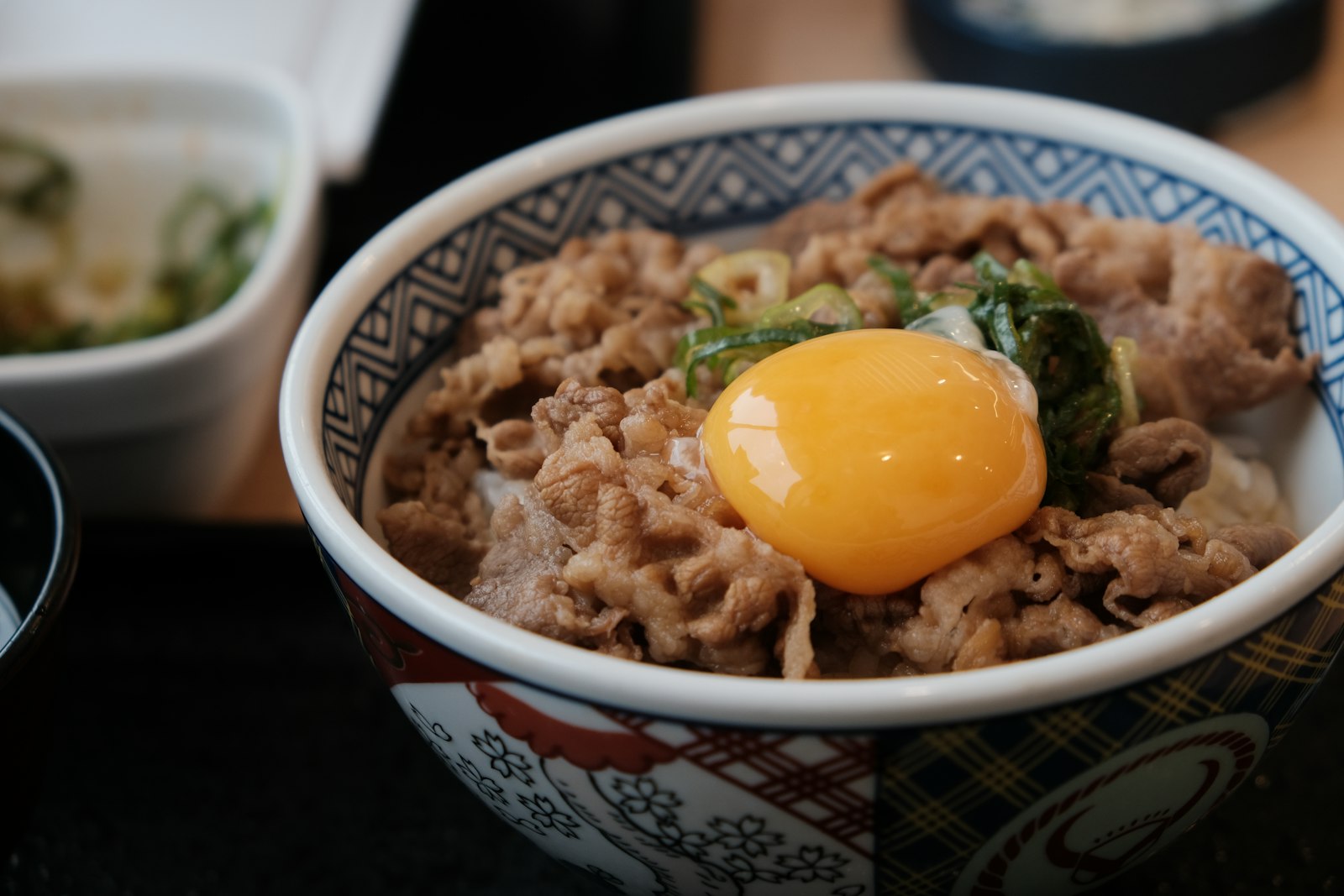 Japanese dinners: gyudon beef bowl topped with an egg yolk