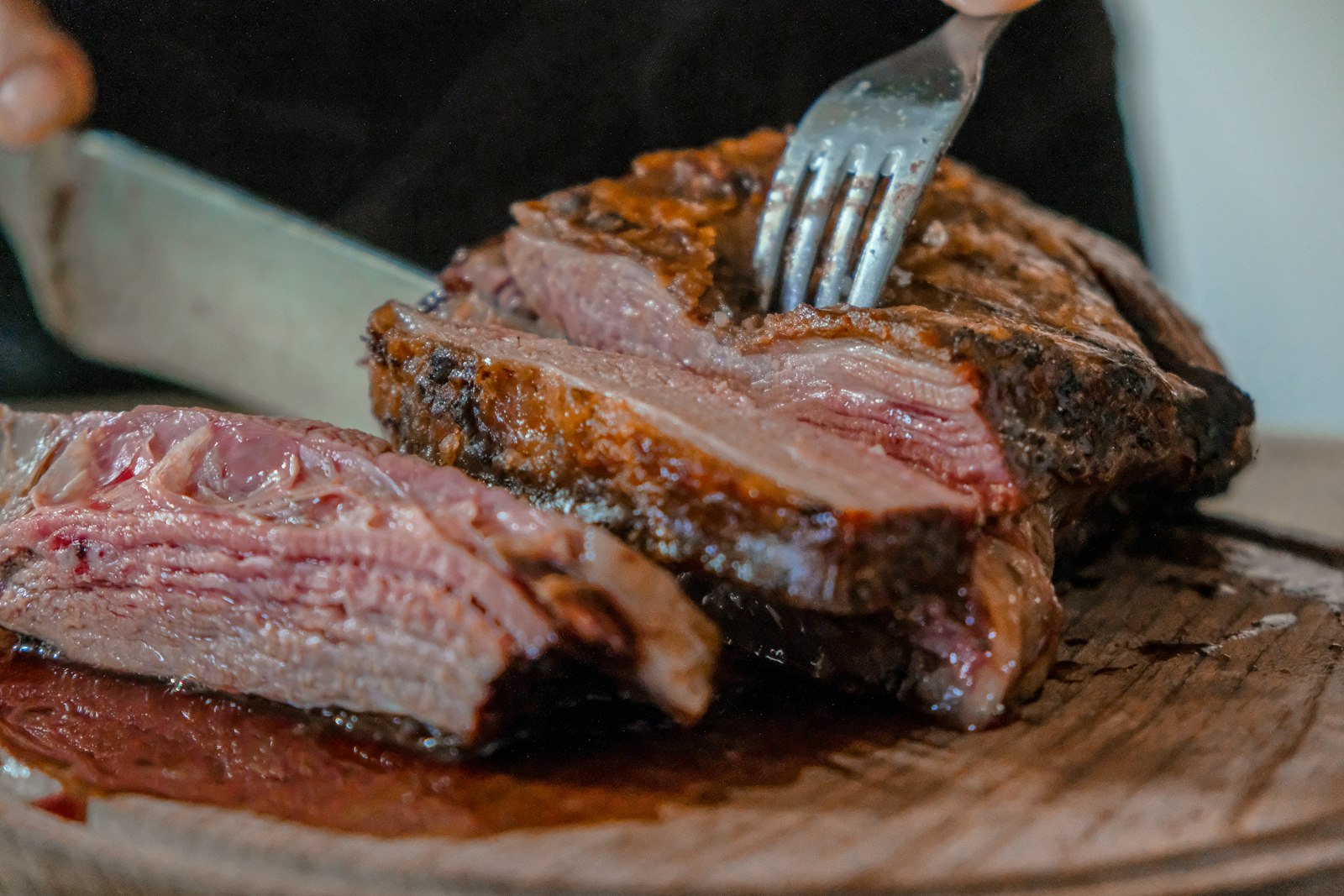 Sliced roast leg with a pink center on a board