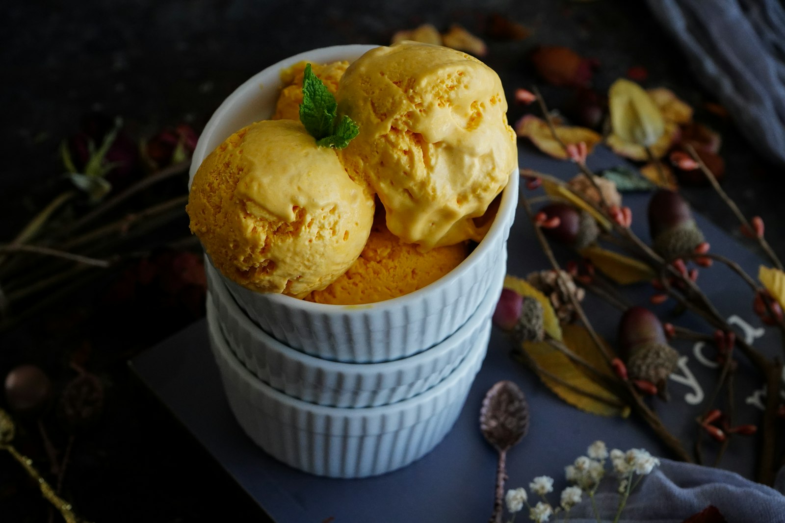Scoops of mango ice cream in a ramekin
