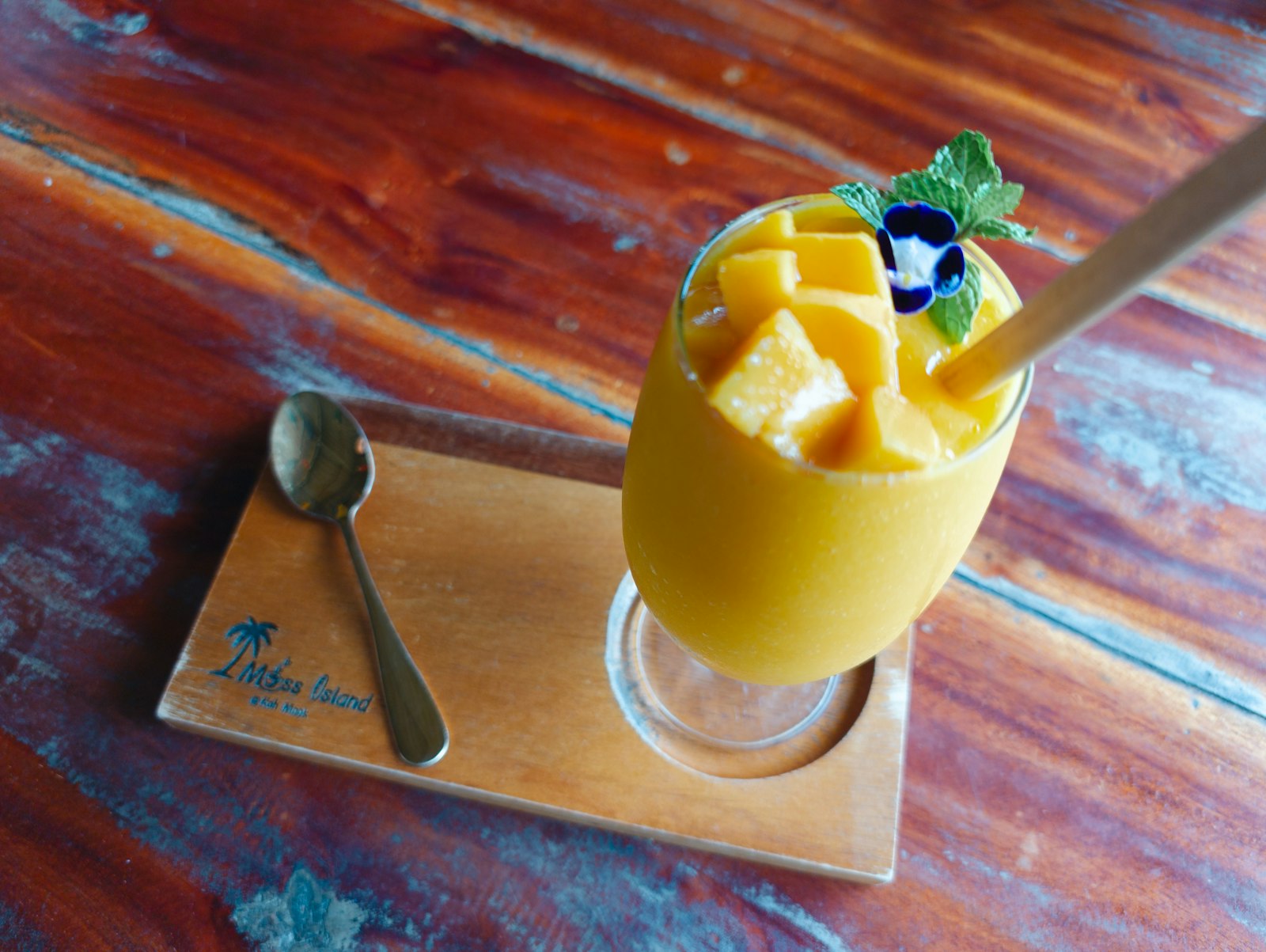 Mango mousse in a glass topped with fresh mango