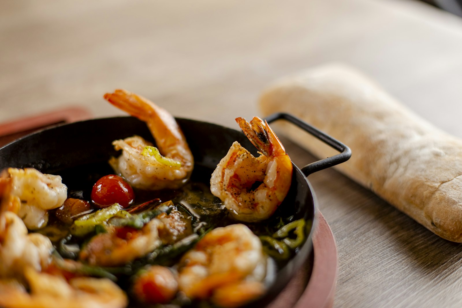 Spicy garlic shrimp in a skillet with bread