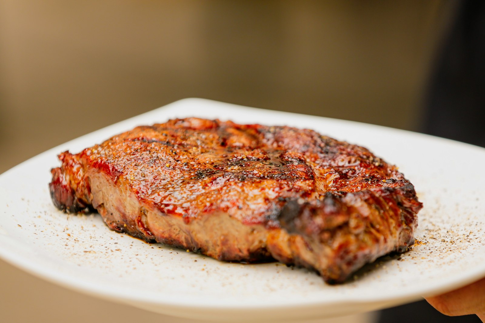 Glazed barbecue steak on a white plate