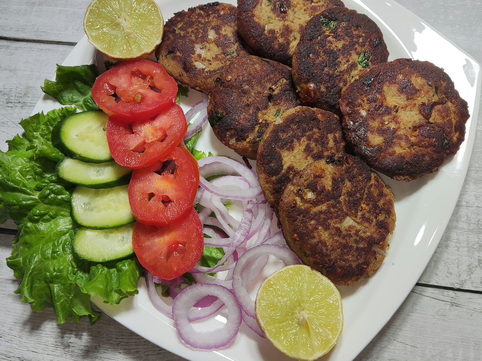 Chapli kebabs with tomato and onion, a Pakistani dinner favorite