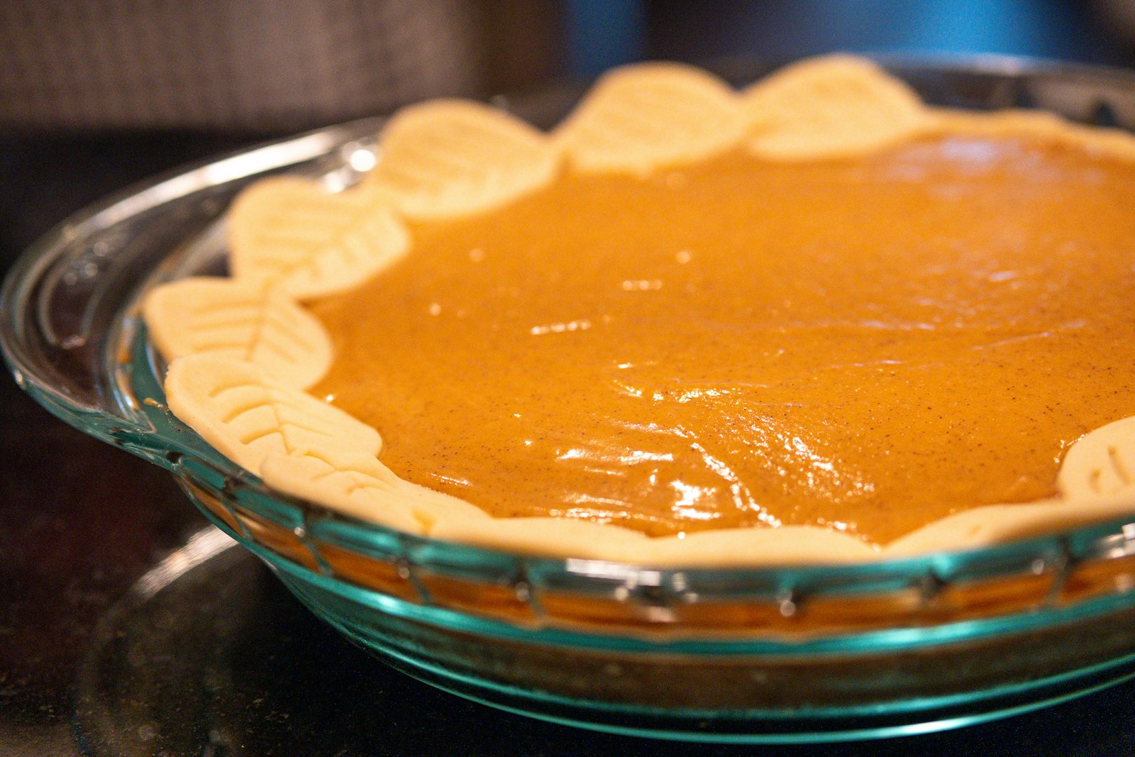 Sweet potato pie with a fluted crust in a glass dish