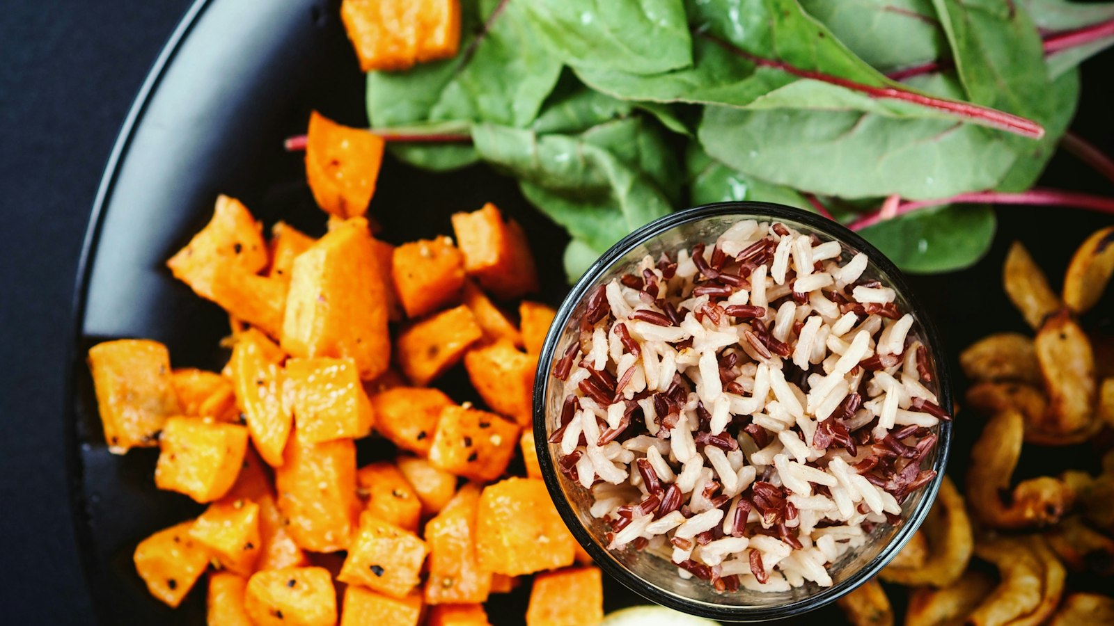 Roasted sweet potato cubes with greens for a fall salad