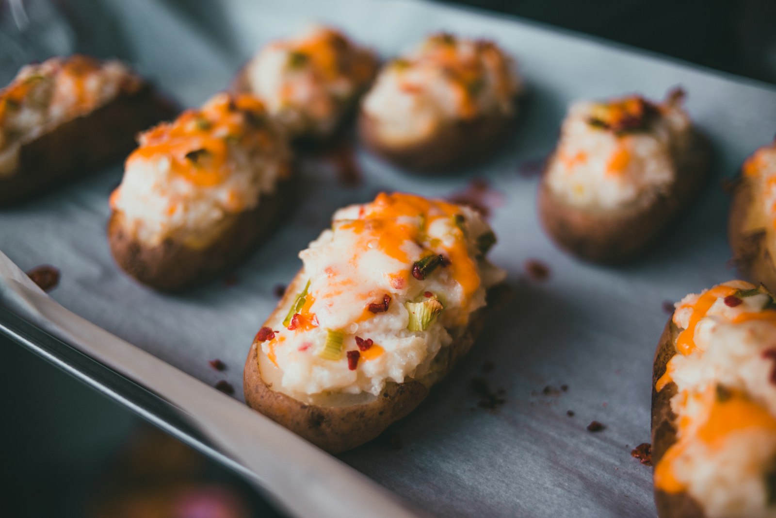 Twice baked stuffed skins with melted cheese on a sheet pan