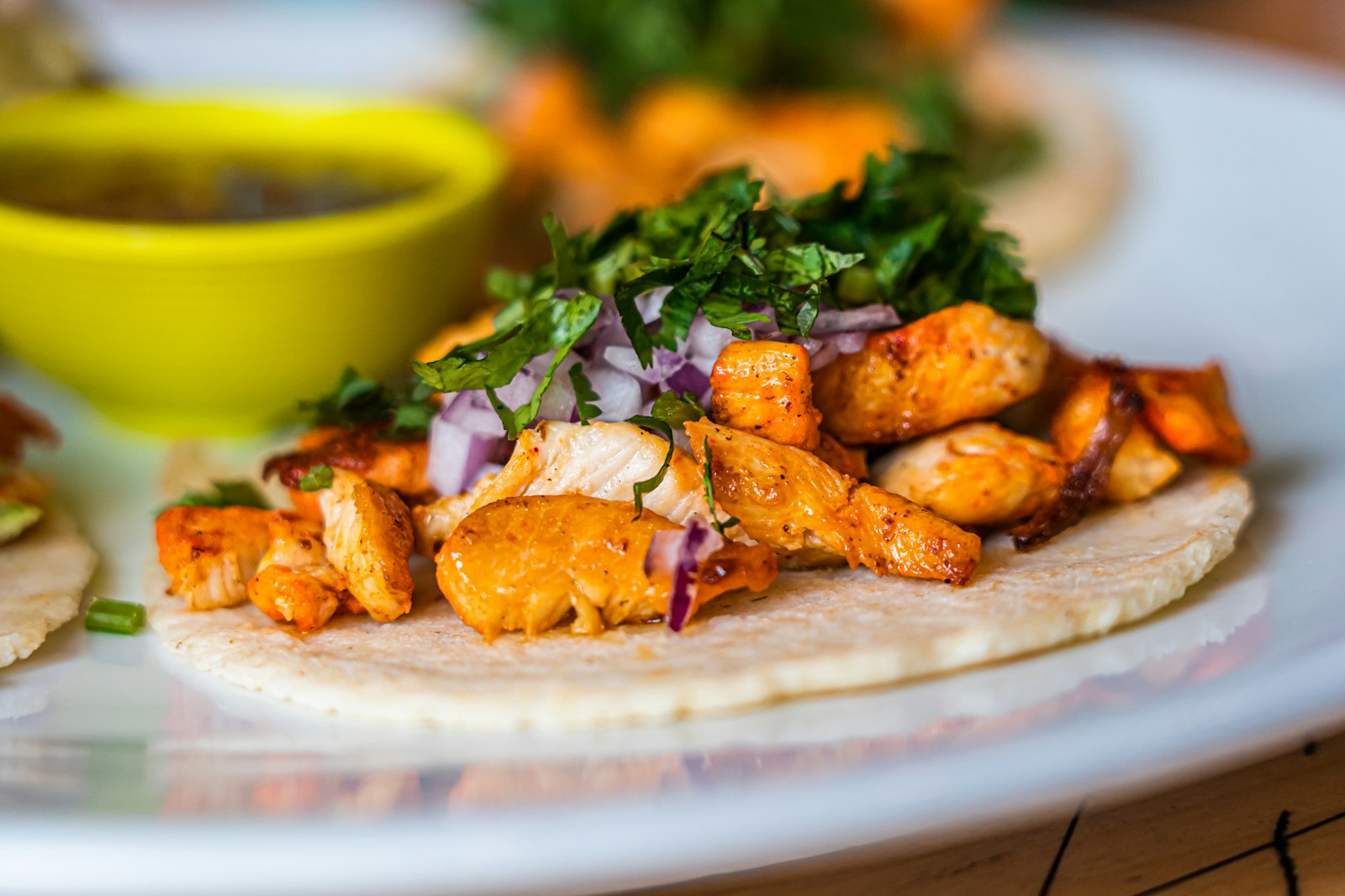 Soft tacos filled with roasted orange cubes and greens