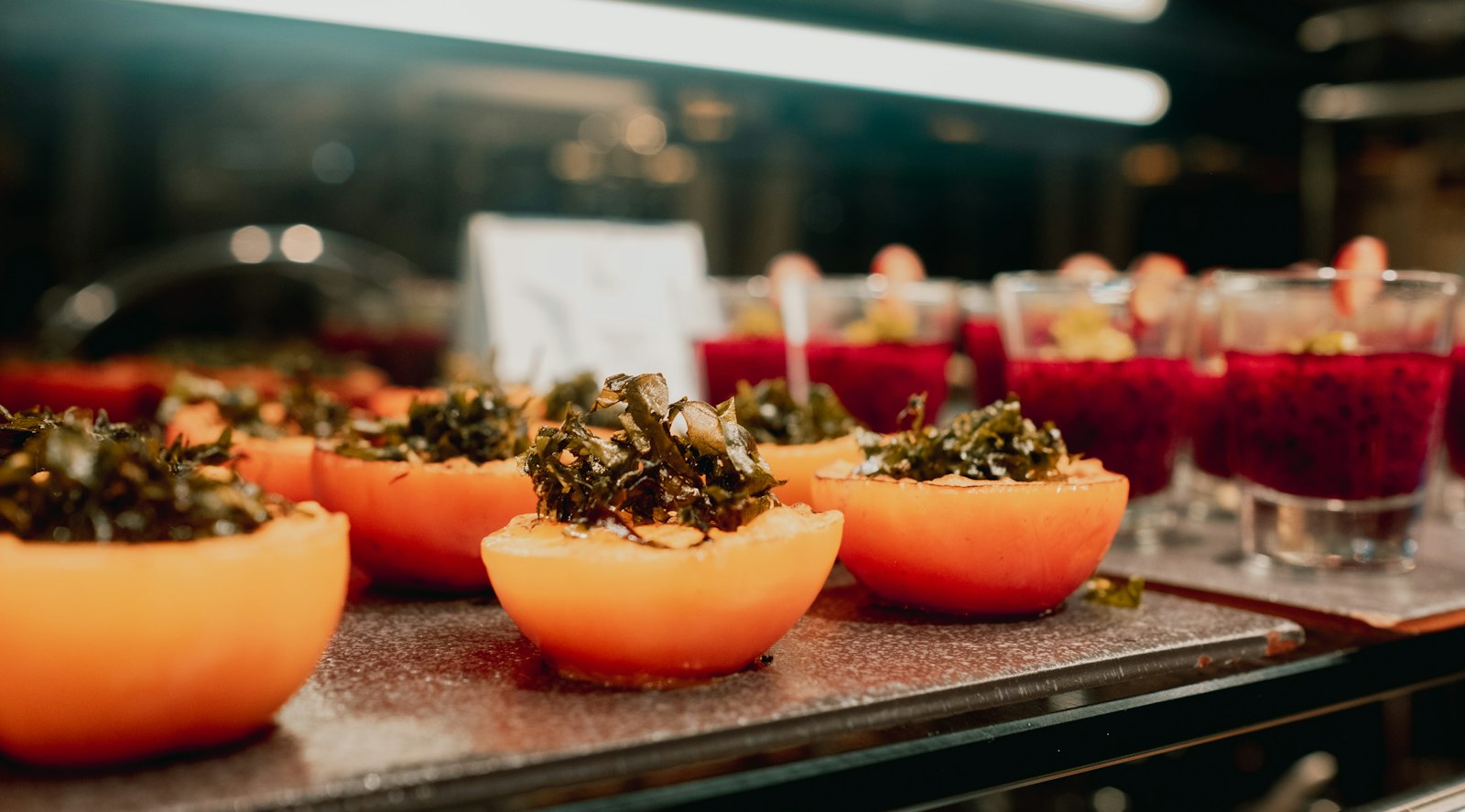 Tomatoes filled with herbed rice on a buffet tray