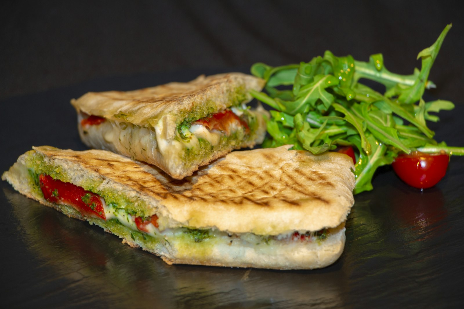 Grilled panini halves with arugula