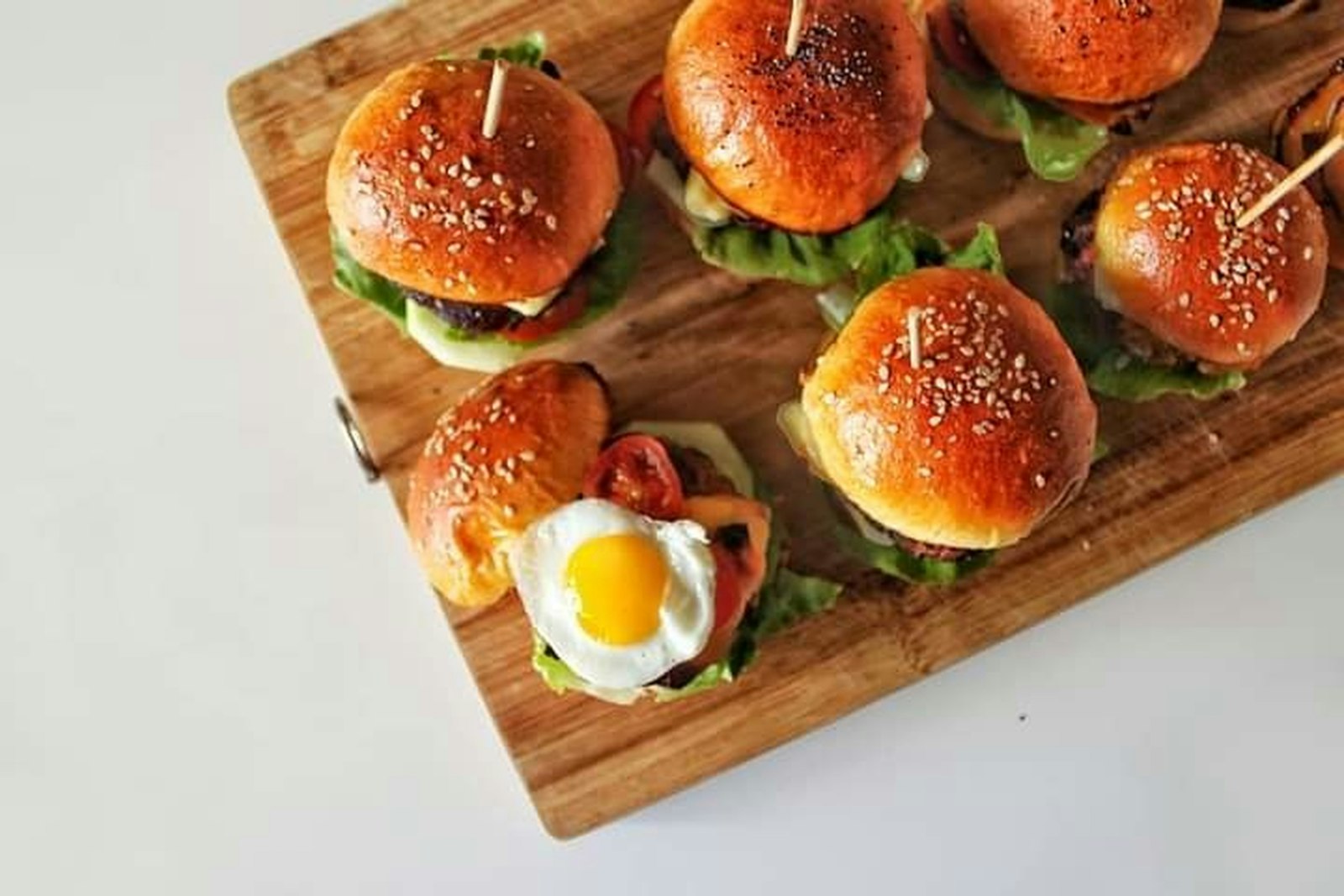 Hot sandwiches: cheesy sliders on a wooden board