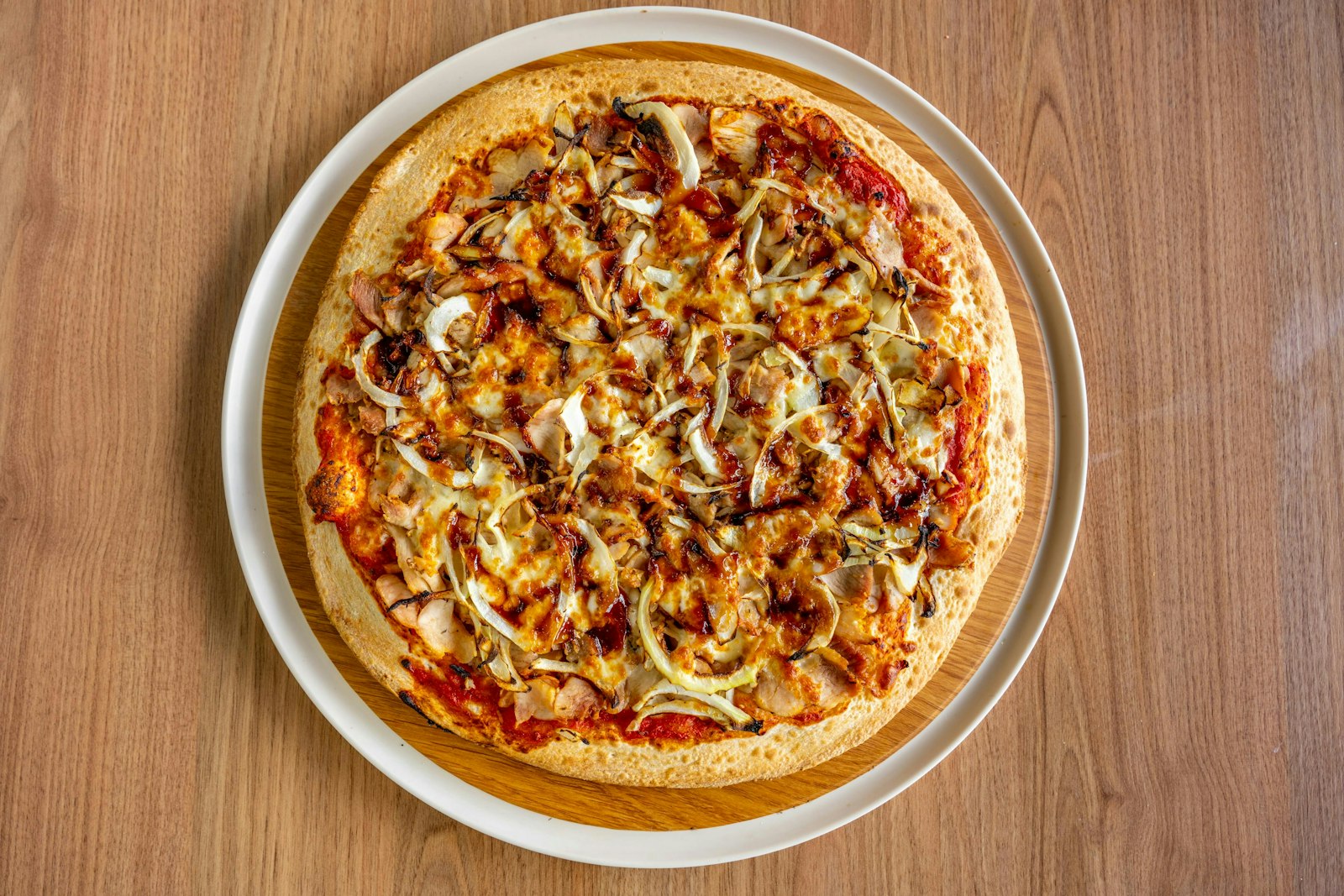 Chicken pizza with red onion and melted cheese