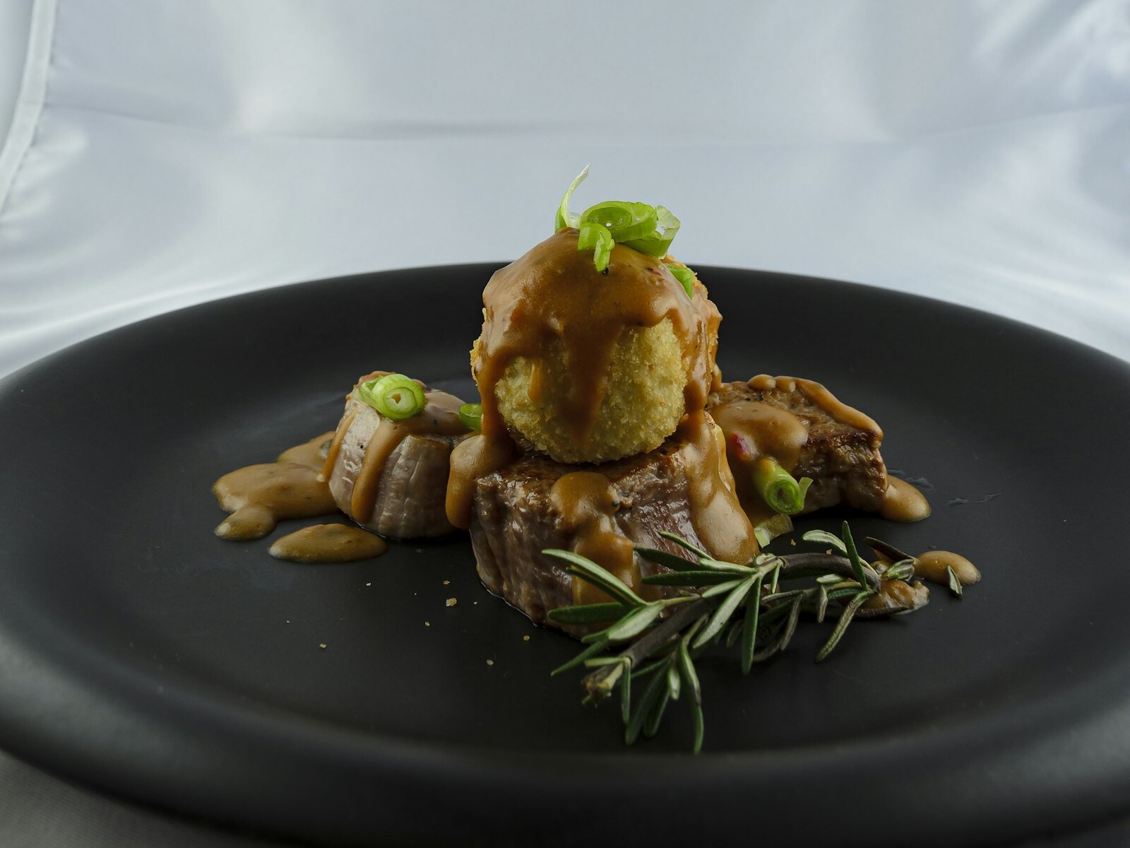 Sliced pork tenderloin with a sweet glaze on a plate