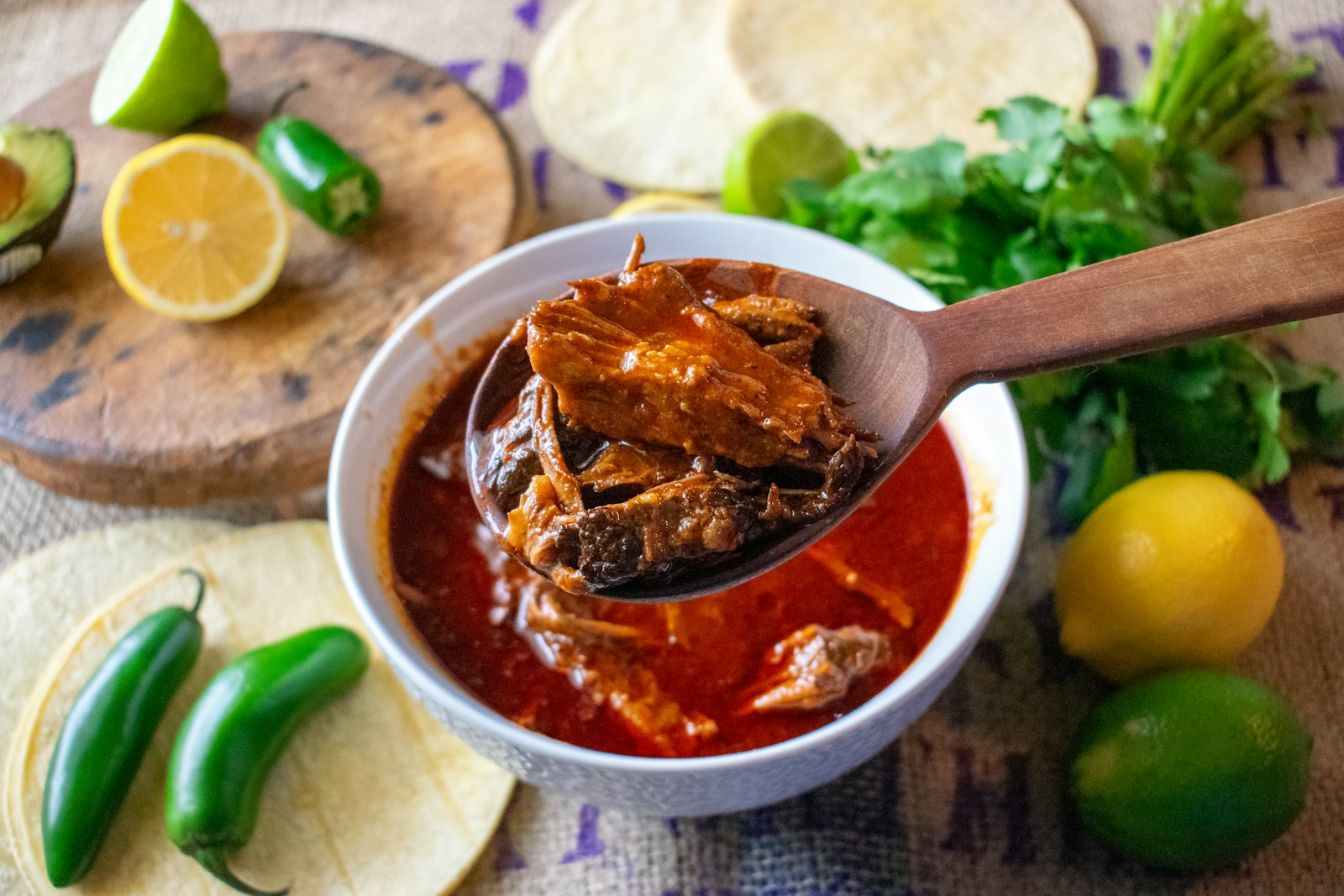 Chili recipes classic: Texas style beef chili with a ladle, lime and tortillas