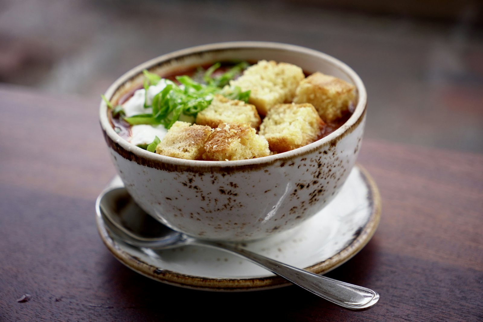 Chili recipes with a twist: creamy white chicken chili topped with crunchy bits and herbs