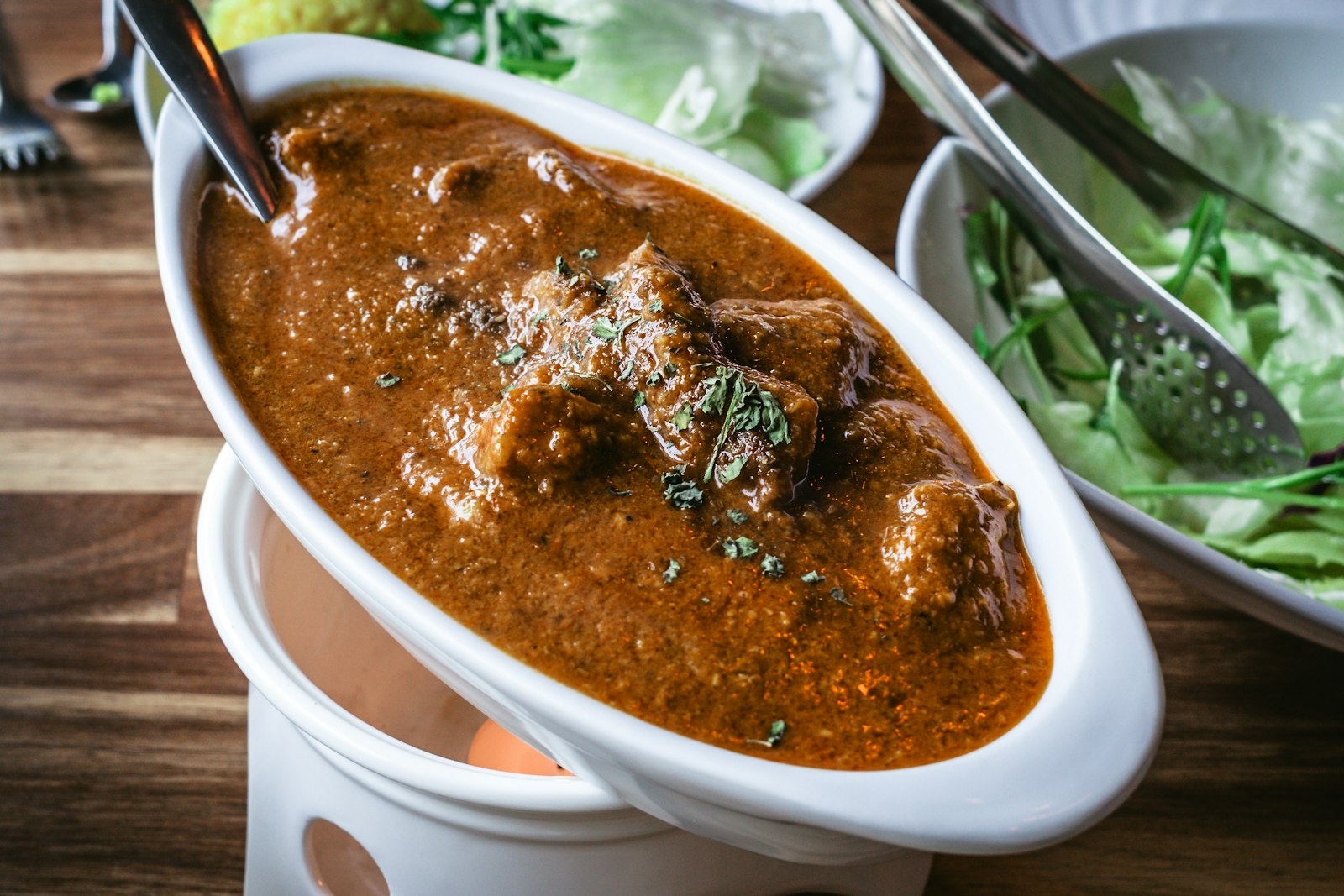 Caribbean curry goat in a white bowl