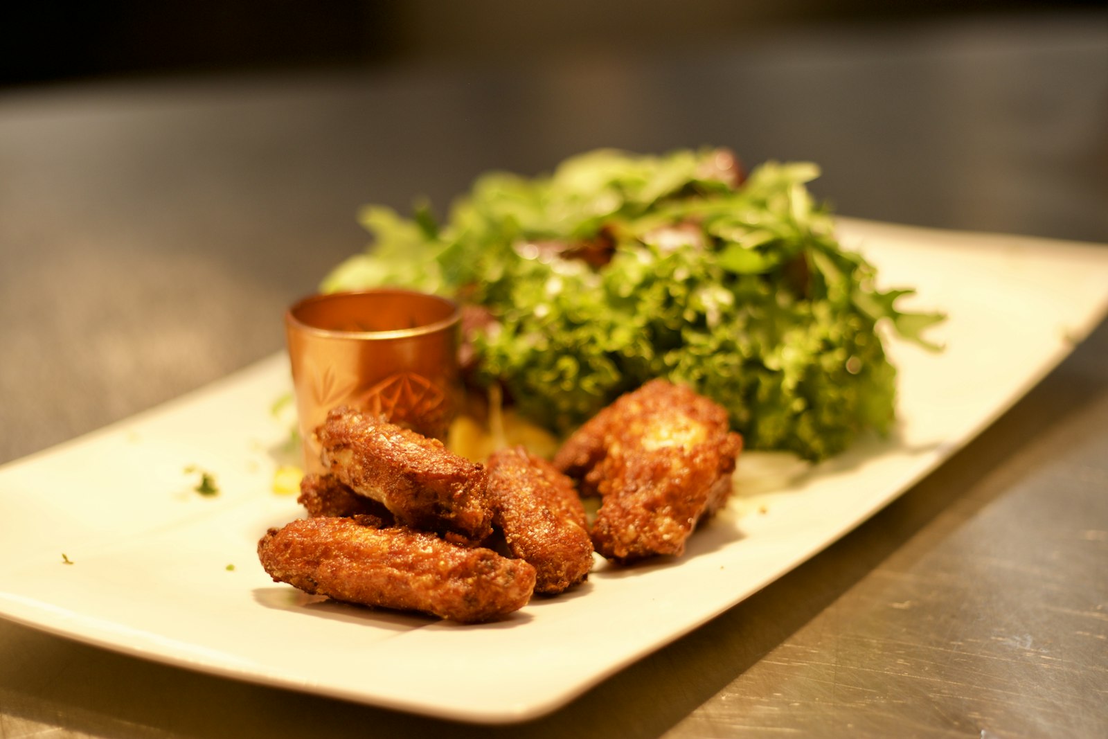 Crispy buffalo chicken tenders with salad
