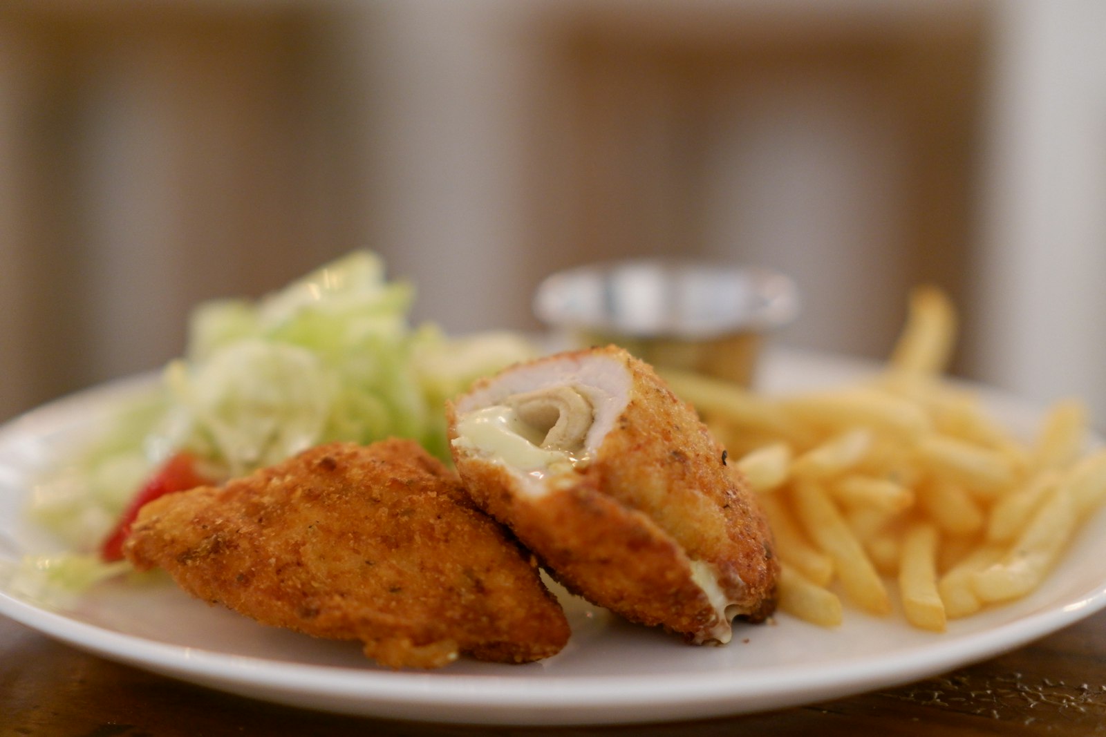 Golden chicken cordon bleu with fries and salad